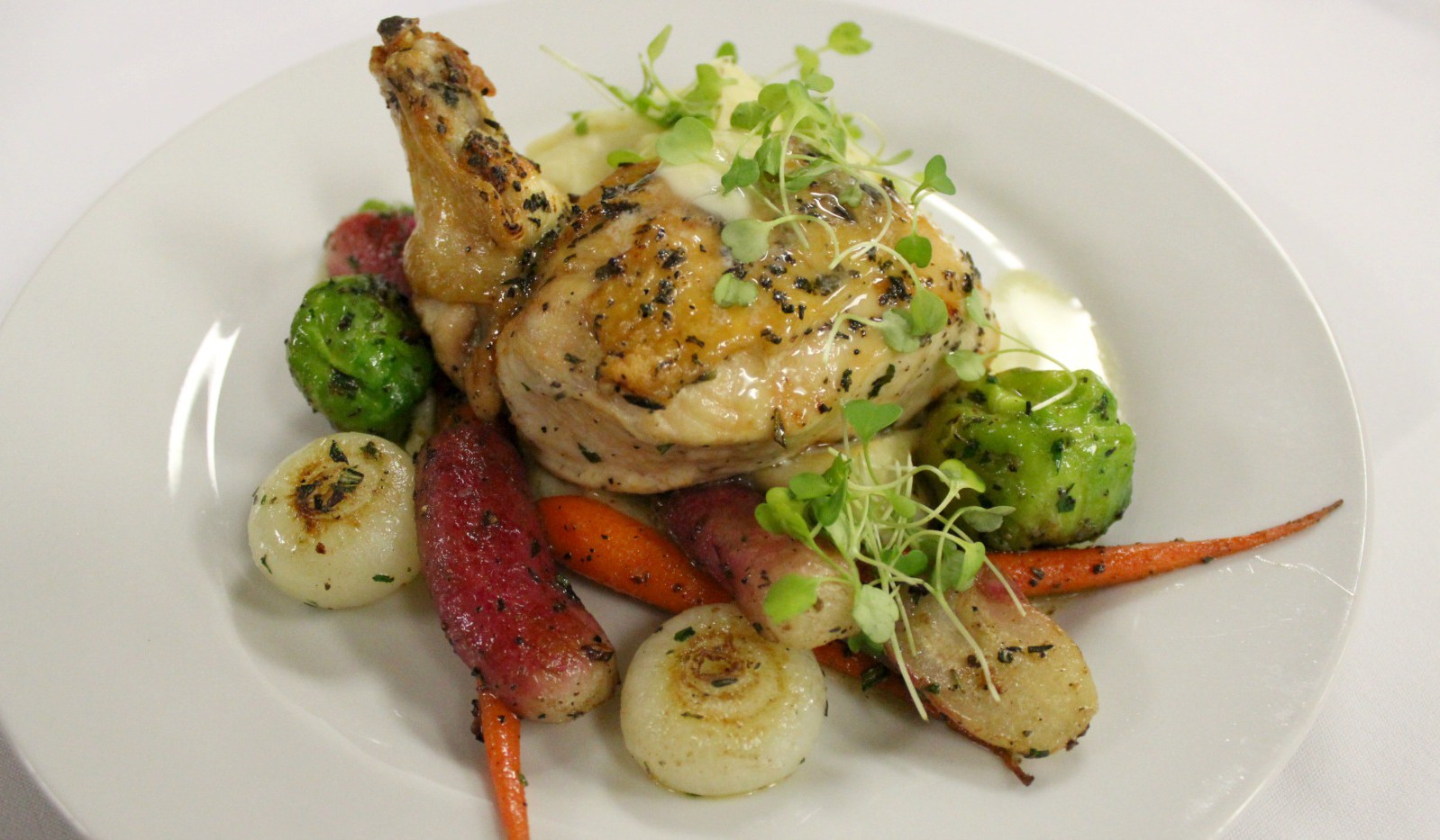 Roasted chicken over fresh vegetables 